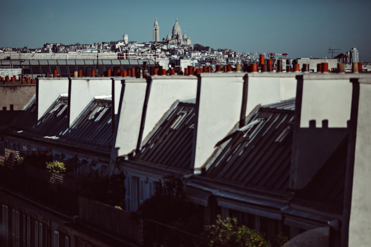 เมอซิเยอ ฌอร์จ โฮเทล แอนด์ สปา - ช็องเซลิเซ่ Hotel ปารีส ภายนอก รูปภาพ View of the roofs of Paris
